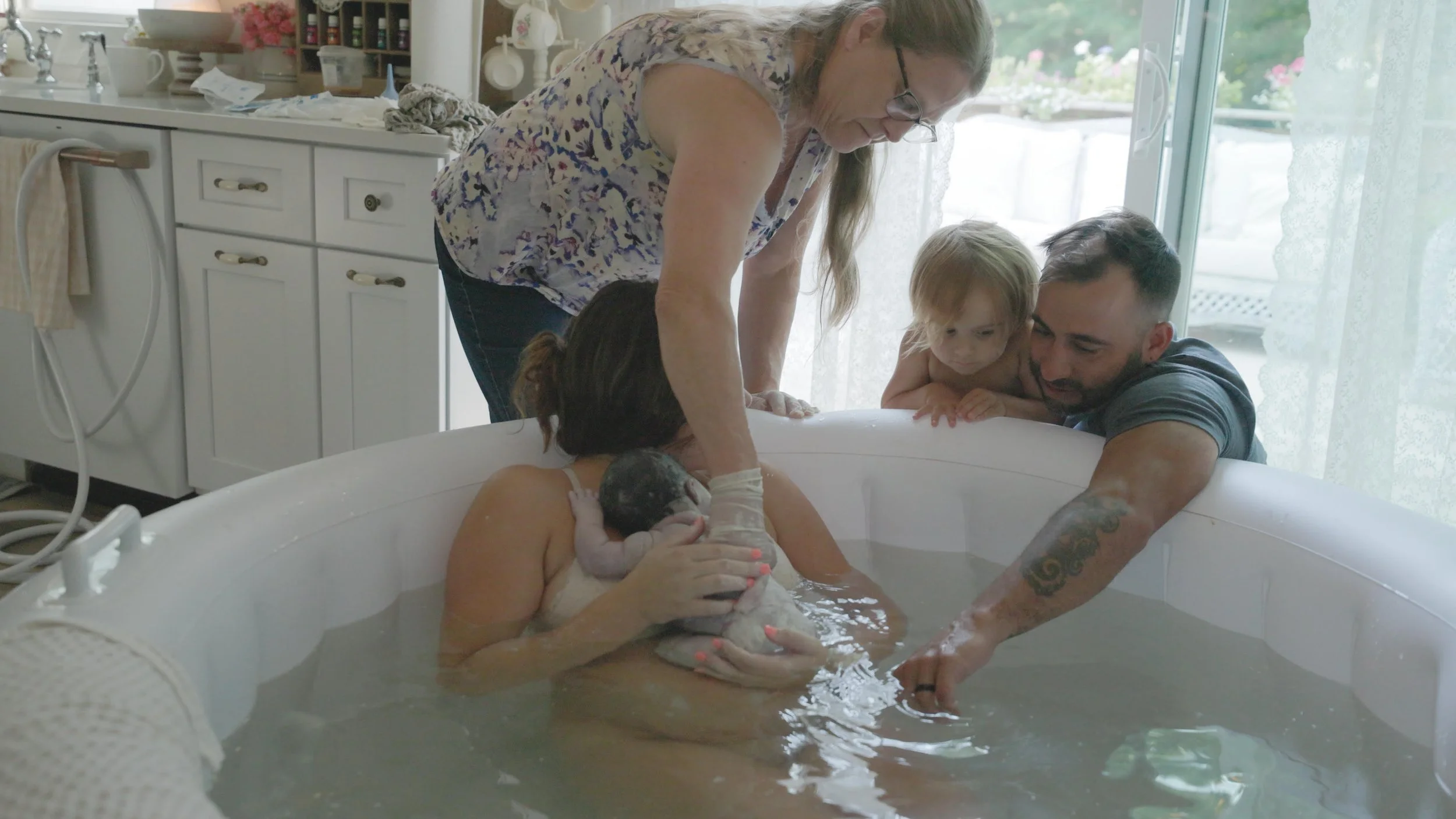 A family meeting their newborn at home